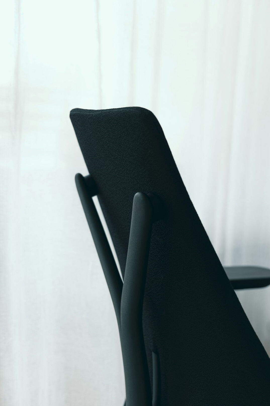 Two empty armchairs facing each other in a bright office, symbolizing conversation